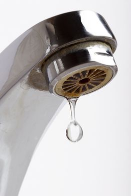 Plumbers fix leaking taps